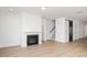 Bright living room with wood-look floors, a fireplace, recessed lighting, and a black sliding barn door at 1237 Porters Call Dr, Wendell, NC 27591