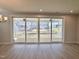 Bright living room featuring wood floors and large sliding glass doors leading to the backyard at 1237 Porters Call Dr, Wendell, NC 27591