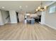Open living room leading to a kitchen with white and navy cabinets, an island and modern stainless steel appliances at 1237 Porters Call Dr, Wendell, NC 27591