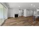 Open-concept living room with fireplace, sliding glass doors, and hardwood floors at 1237 Porters Call Dr, Wendell, NC 27591