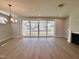 Bright living room featuring a fireplace, wood floors and large sliding glass doors to the backyard at 1237 Porters Call Dr, Wendell, NC 27591