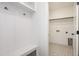 Well-organized mudroom with custom bench, hooks, and ample storage space, leading to laundry at 1237 Porters Call Dr, Wendell, NC 27591