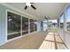 Covered patio features ceiling fans, wood flooring, and sliding glass doors at 1237 Porters Call Dr, Wendell, NC 27591