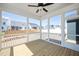 Screened-in porch with wooden floors, white railings, and ceiling fan at 1237 Porters Call Dr, Wendell, NC 27591
