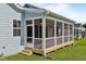 Close-up of a screened porch with white railings and a view of the backyard at 1237 Porters Call Dr, Wendell, NC 27591