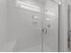 Modern tiled shower features glass door, window, and built-in shower bench at 1237 Porters Call Dr, Wendell, NC 27591