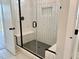 Bathroom featuring glass enclosed shower with built-in bench and matte black fixtures at 1237 Porters Call Dr, Wendell, NC 27591