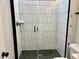 Glass shower with white subway tile and black fixtures at 1237 Porters Call Dr, Wendell, NC 27591