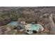 Aerial shot features community amenities: pool, tennis courts, and more, nestled among mature trees at 1326 Apache Ln, Apex, NC 27502