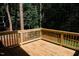 A spacious wood deck in a backyard surrounded by trees at 1326 Apache Ln, Apex, NC 27502