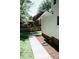A well-maintained backyard with a walkway and a view of the neighbor's deck at 1326 Apache Ln, Apex, NC 27502