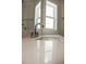 Bright bathroom featuring a modern faucet and a window providing natural light at 1326 Apache Ln, Apex, NC 27502
