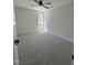A carpeted bedroom with a ceiling fan and a window at 1326 Apache Ln, Apex, NC 27502