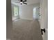 A carpeted bedroom with a ceiling fan and a window at 1326 Apache Ln, Apex, NC 27502