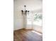 Light-filled dining room with wood floors, wainscoting and large bay window at 1326 Apache Ln, Apex, NC 27502