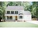 Charming white two-story home boasts a welcoming front porch and well-manicured lawn at 1326 Apache Ln, Apex, NC 27502