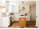 This renovated kitchen features an island, stainless steel appliances, and pendant lighting at 1326 Apache Ln, Apex, NC 27502