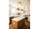Beautiful kitchen with white cabinets, an island with quartz countertop, and stainless steel appliances at 1326 Apache Ln, Apex, NC 27502