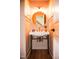 Charming powder room showcases vessel sink with custom mirror and accent lighting at 1326 Apache Ln, Apex, NC 27502