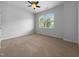 A bright bedroom featuring neutral walls, carpeted flooring, and a window providing ample natural light at 1412 Wesser Ct, Fuquay Varina, NC 27526
