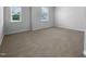 Bright bedroom with neutral carpet and two windows offering natural light at 1412 Wesser Ct, Fuquay Varina, NC 27526