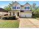 Charming two-story home featuring a well-manicured lawn and inviting front porch with stylish architectural details at 1412 Wesser Ct, Fuquay Varina, NC 27526