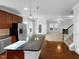 Open kitchen with granite countertops, wooden cabinets, and seamless flow into living and dining areas at 1412 Wesser Ct, Fuquay Varina, NC 27526