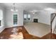 Open concept living area with hardwood floors, carpet, fireplace, and access to outdoor space at 1412 Wesser Ct, Fuquay Varina, NC 27526