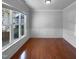 Bright living room with hardwood floors, white trim, and a large window offering an outdoor view at 1412 Wesser Ct, Fuquay Varina, NC 27526