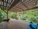 Outdoor deck with pergola overlooking a lush backyard with mature trees and landscaping at 1604 Meadow Ln, Chapel Hill, NC 27516