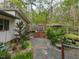 Backyard featuring mature landscaping, stone pathways and a greenhouse at 1604 Meadow Ln, Chapel Hill, NC 27516
