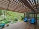 Relaxing backyard featuring a deck with comfortable seating overlooking a serene wooded area at 1604 Meadow Ln, Chapel Hill, NC 27516