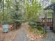 Backyard featuring mature landscaping, stone pathways and a greenhouse at 1604 Meadow Ln, Chapel Hill, NC 27516