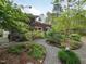 Serene backyard with mature landscaping, stone pathways, screened in porch and pergola at 1604 Meadow Ln, Chapel Hill, NC 27516