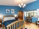 Comfortable bedroom featuring hardwood floors, a cozy bed, and a tranquil view from the window at 1604 Meadow Ln, Chapel Hill, NC 27516