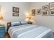 Comfortable bedroom featuring a bed with blue and white patterned bedding, complemented by artwork on the walls at 1604 Meadow Ln, Chapel Hill, NC 27516