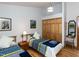 Bright bedroom featuring two beds, hardwood floors, and a closet, ideal for guests or Gathering at 1604 Meadow Ln, Chapel Hill, NC 27516