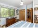 Bedroom with hardwood floors, large windows overlooking the forest, and wooden furnishings at 1604 Meadow Ln, Chapel Hill, NC 27516