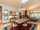 Open dining room with wood table, vaulted ceiling, skylight, view to the living room, and hardwood floors at 1604 Meadow Ln, Chapel Hill, NC 27516