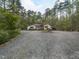 Charming home showcasing a gravel driveway with lush landscaping at 1604 Meadow Ln, Chapel Hill, NC 27516