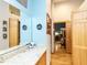 Hallway with a built-in vanity, a large mirror, and wood accents at 1604 Meadow Ln, Chapel Hill, NC 27516