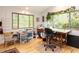Bright home office with large windows offering wooded views, hardwood floors, and ample desk space at 1604 Meadow Ln, Chapel Hill, NC 27516