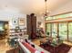 Open living room with vaulted ceilings, wood stove, stone accent wall, and access to the deck at 1604 Meadow Ln, Chapel Hill, NC 27516