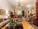 Open-concept living area with hardwood floors, modern lighting, and views of the kitchen at 1604 Meadow Ln, Chapel Hill, NC 27516