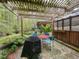 Outdoor patio area with pergola, stone pavers and barbeque at 1604 Meadow Ln, Chapel Hill, NC 27516