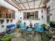 Charming outdoor patio with a pergola, unique decor, and comfortable blue seating at 1604 Meadow Ln, Chapel Hill, NC 27516