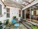Relaxing patio featuring a pergola, eclectic decor, and sliding door access to the home at 1604 Meadow Ln, Chapel Hill, NC 27516