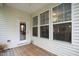 Cozy back porch featuring natural wood flooring and bright windows letting in warm, natural light at 184 Wildfell Trl, Cary, NC 27513