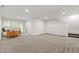 Large basement area with neutral carpeting, ample natural light, and access to the outside, perfect for flexible space at 184 Wildfell Trl, Cary, NC 27513