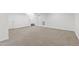 Neutral carpeted basement with access to a staircase, perfect for a home office, gym, or recreational space at 184 Wildfell Trl, Cary, NC 27513